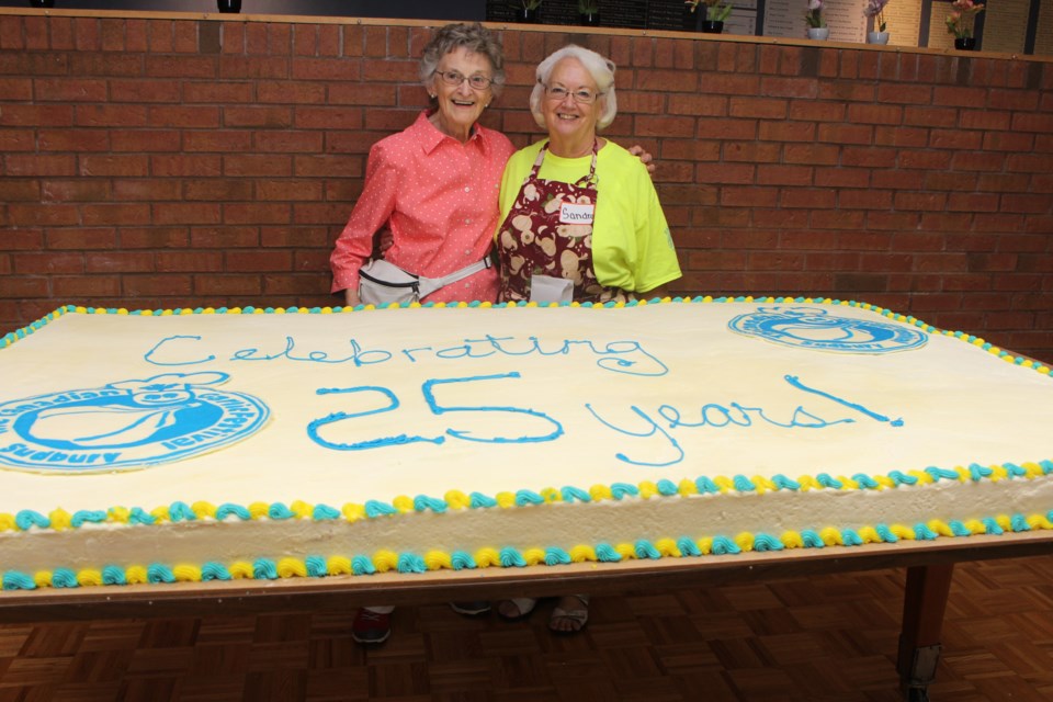 Canadian Garlic Festival co-founder Mary Stefura and festival chair Sandra Sharko celebrated its 25th anniversary Sunday with a giant cake. Photo by Jonathan Migneault.