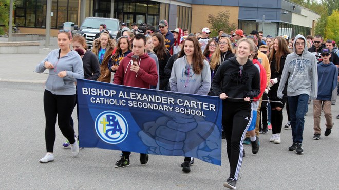 Bishop Alexander Carter Catholic Secondary School staff and students joined family members for an annual fundraising memorial walk in memory of Mackenzie Rooney and Dennis Dechaine