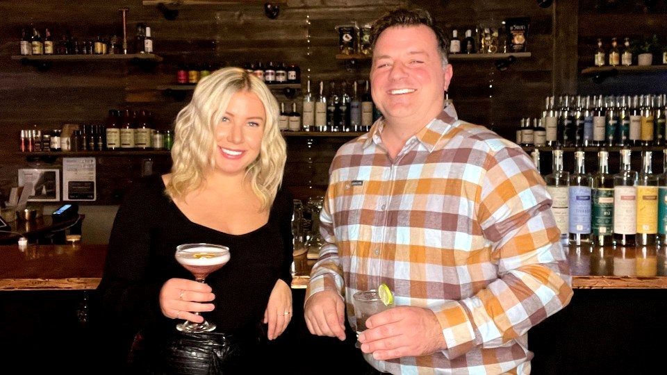 Events Coordinator Corissa Blaseg and  owner and mad scientist behind the spirits, Shane Prodan stand at the bar in Crosscut Distillery.
