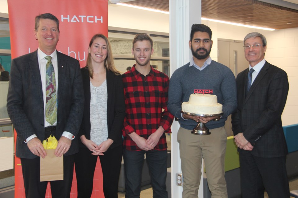 After Hatch Engineering announced a $250,000 scholarship fund for Laurentian University's Bharti School of Engineering on Jan. 30, studentspresented company reps with a cake in celebration of the company's 30th anniversary in Greater Sudbury. From left are Bruce MacKay, Hatch's regional managing director for Western North America, engineering students Sara Hicks, Joel Venne and Harsh Brahmbhatt, and Victor Violin, Hatch's project manager for the Vale-Glencore synergy project. (Heidi Ulrichsen/Sudbury.com)

