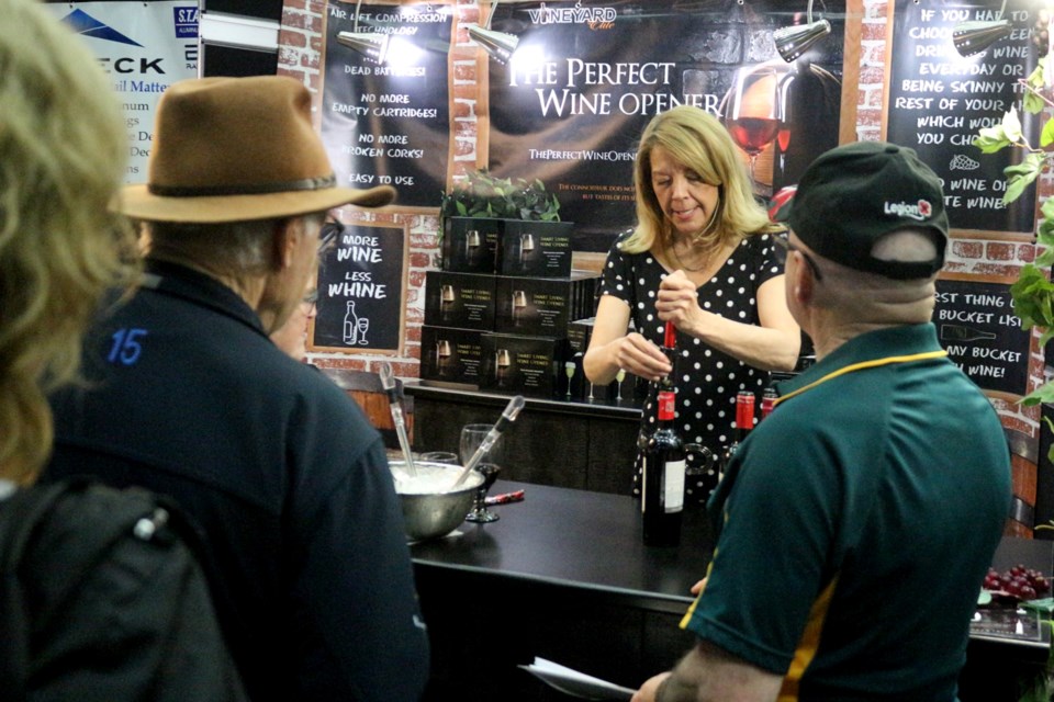 Nicole Beaumont of Perfect Wine Opener demonstrates the product for visitors to the 2023 Home and Lifestyle Show.