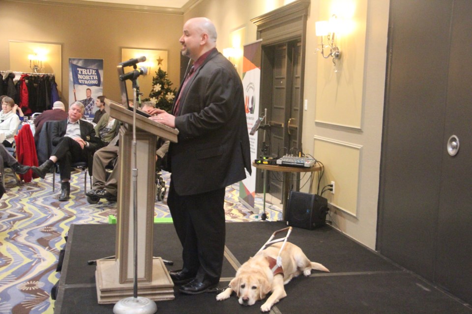 Independent Living Sudbury Manitoulin executive director Rob DiMeglio and his guide dog Fianna at the 10th annual Persons with Disabilities Breakfast Nov. 30. (Heidi Ulrichsen/Sudbury.com)