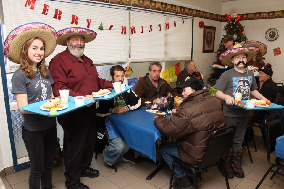 Volunteers with the Blue Door Soup Kitchen prepared a Mexican feast for visitors on Friday to ring in the new year. The downtown soup kitchen has decided to celebrate different international cuisines to give visitors a good meal ahead of New Year's Eve. Photo by Jonathan Migneault.