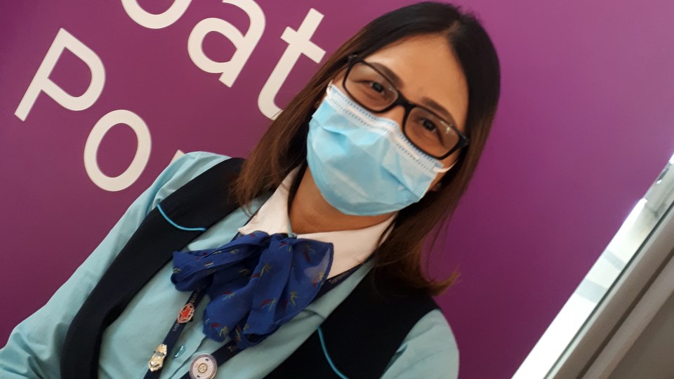 An Airport Authority staff member at Pearson Airport wears a face mask as protection against coronavirus. (Image: Hugh Kruzel)