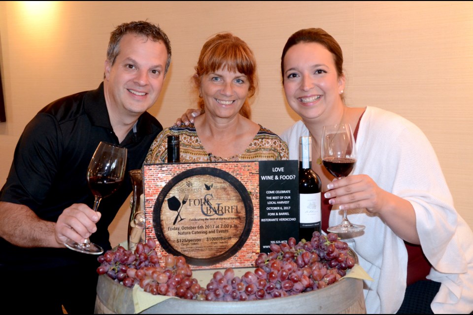 Northern Cancer Foundation executive director Tannys Laughren, centre, organizing committee member Samantha Kuula and Ristorante Verdicchio owner Mark Gregorini share a toast at the launch of Fork & Barrel on Aug. 31. (Photo: Arron Pickard)
