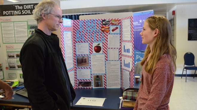 Amber Wiwchar, of C.C. McLean Public School in Gore Bay, talks about her project, Bubbly Bacteria, with teacher Bruce Lindsay. Photo by Arron Pickard.