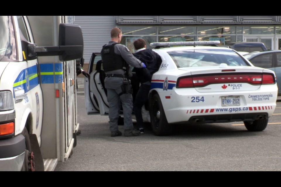 Greater Sudbury Police put the stabbing suspect in the back of a police cruiser following his arrest June 3. (Heather Green-Oliver / Sudbury.com)