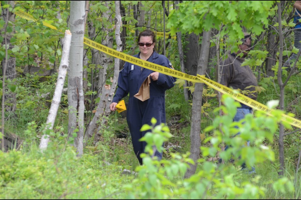 Greater Sudbury Police Service and the coroner's office are investigating possible human remains found in a wooded area behind 725 Bruce Ave., in the Donovan. Photo by Arron Pickard