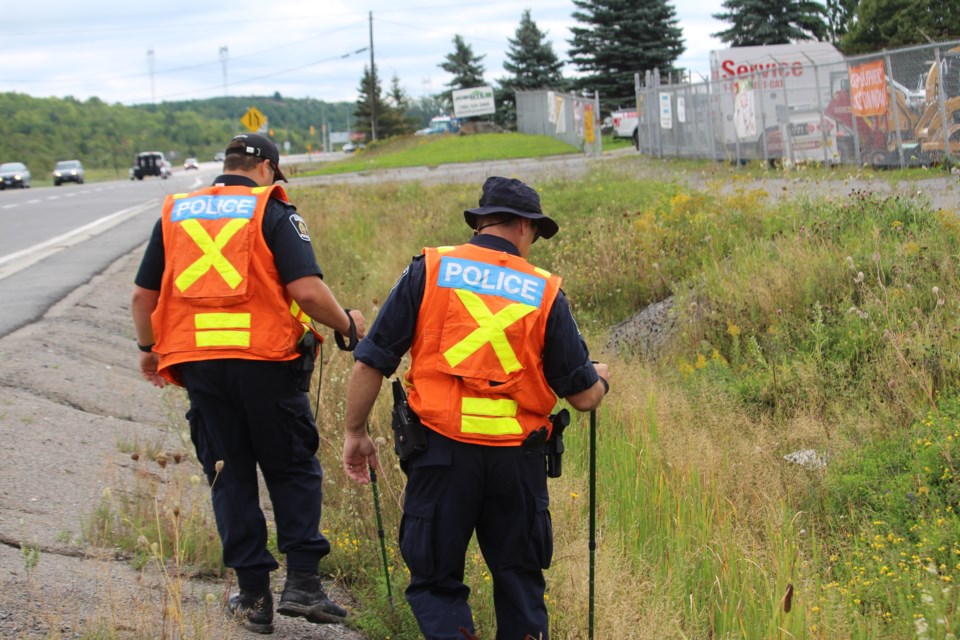 Several Greater Sudbury Police officers were searching the side of the road on Highway 17 near Coniston this morning. Photo by Patrick Demers.