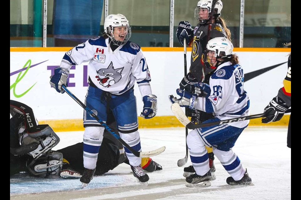 Lady Wolves forward Katie Chomiak celebrates her second period goal, as forward Taylor Scott looks on. (Alex D'Addese/Hockey Canada Images)