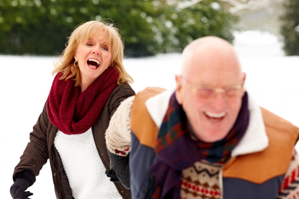 senior-couple-enjoying-themselves-in-winter-forest