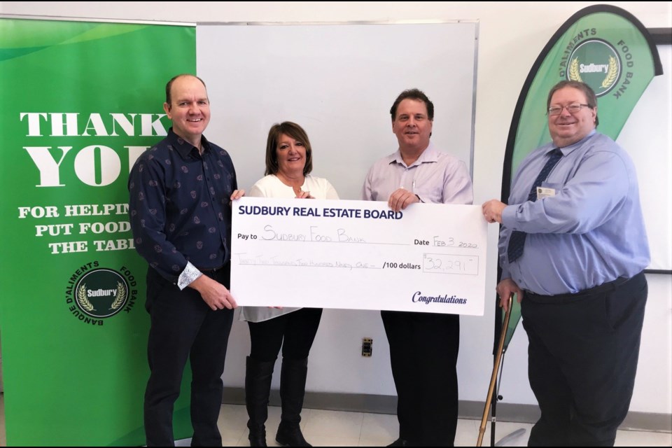 SREB President Dan Gray, 2019 Christmas committee chair Ginette Spooner, and Ryan Kirwan, of HQ Mortgages, hosted a cheque presentation at the Sudbury Food Bank. Executive director Dan Xilon accepted the cheque. (Supplied)