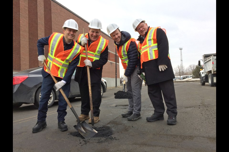 Minister of Infrastructure and Communities, Francois-Philippe Champagne, Sudbury MP Paul Lefebvre, Nickel Belt MP Marc Serre´ and City of Greater Sudbury Mayor Brian Bigger fill a pothole on Grey Street on March 28. (Heather Green-Oliver/Sudbury.com)