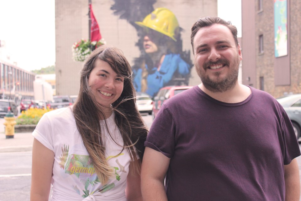 Up Here Festival organizers Jen McKerral and Christian Pelletier stand in front of a new mural by street artist Jarus following the official festival launch Aug. 18. The festival runs all through the weekend featuring some 40 musical acts across 10 downtown venues. (Callam Rodya/Sudbury.com)