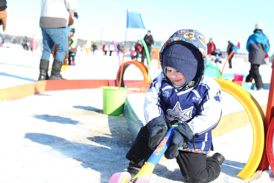 Easton, son of Jessica Gray, enjoys the children's play area of the 2019 Pond Hockey Festival on the Rock at the Northern Water Sports Center (Keira Ferguson/ Sudbury.com)