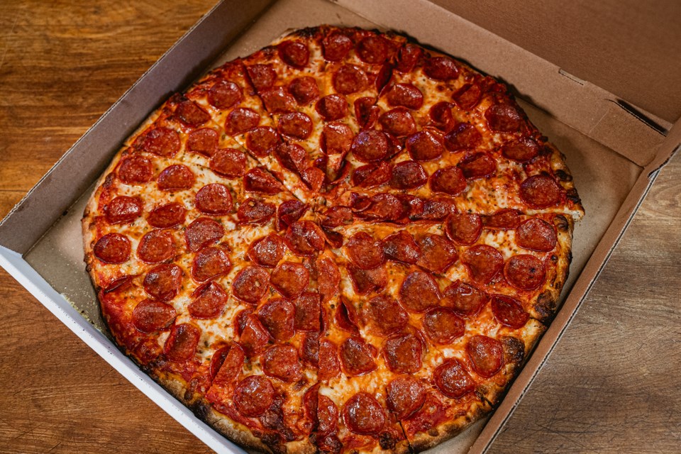 Max enjoys the standard fully loaded pepperoni pizza.  He says customers often wonder if they ordered a double pepperoni pizza because each slice is generously loaded with pepperoni.