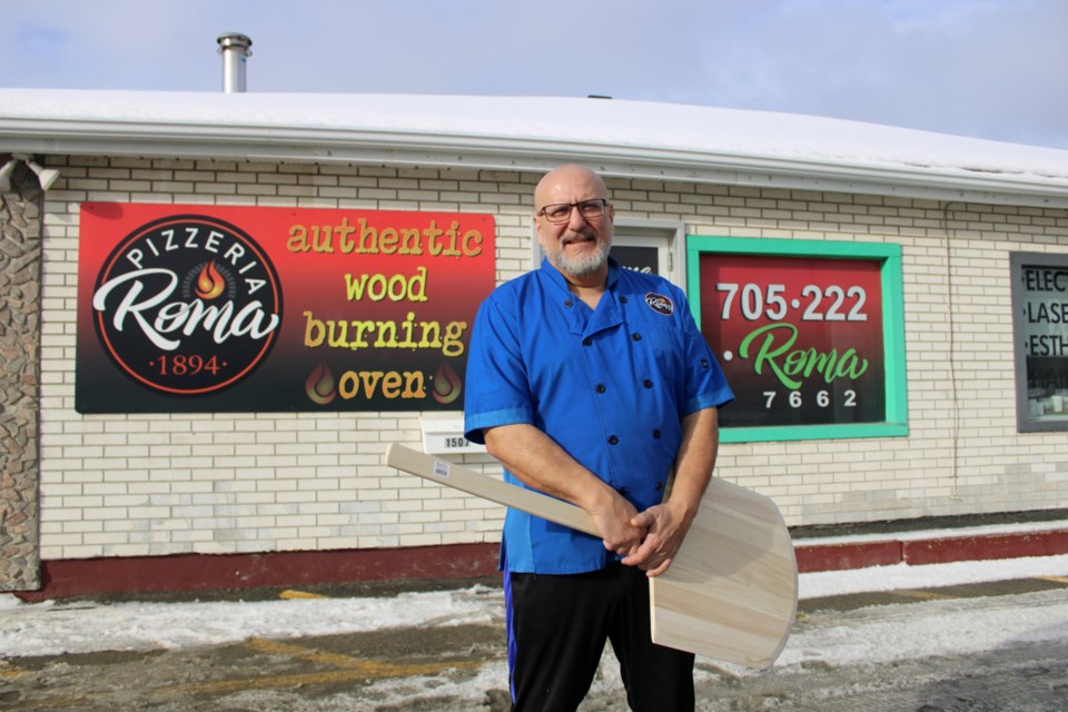 Pizzeria Roma 1894 owner/operator Roberto Ferrucci is seen in his business’s second location at 1507 Paris St., which is expected to open Tuesday. 