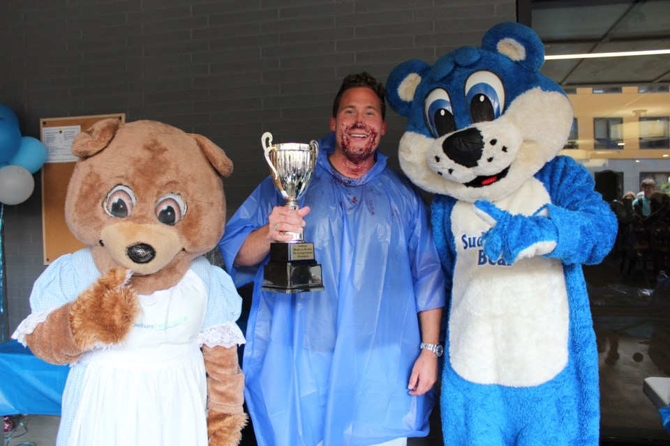 Connor LaRocque, centre, won the Sudbury Blueberry Festival’s Celebrity Pie-Eating Contest. He stands triumphant with Sud-Berry Blueberry Bear and Sudbrina Bear, the festival’s mascots. 