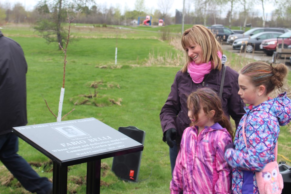 Former ward 8 councillor Fabio Belli's wife Suzie, and daughters Emma and Brianna unveiled a plaque in his honour at Twin Forks community park on May 14. Photo: Matt Durnan