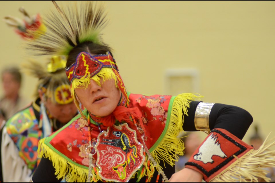 Kihiw Lightning dances in traditional regalia at Cambrian College's powwow on Friday. Photo by Arron Pickard.