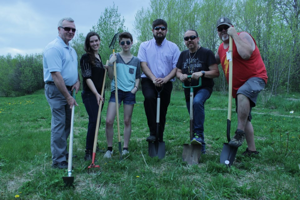 Ward 5 Councilor Robert Kirwan, community organizer with the Social Planning Council of Sudbury, Fionna Tough, Ryan Heights youth Jesse Northover, executive director of the Social Planning Council of Sudbury, Joseph Leblanc, traditional helper Perry McLeod-Shabogesic and president of the Ryan Heights Neighbourhood Association, Sean Wilkinson, officially break ground on the Flour Mill Community Farm at Ryan Heights Park May 17. (Callam Rodya/Sudbury.com)