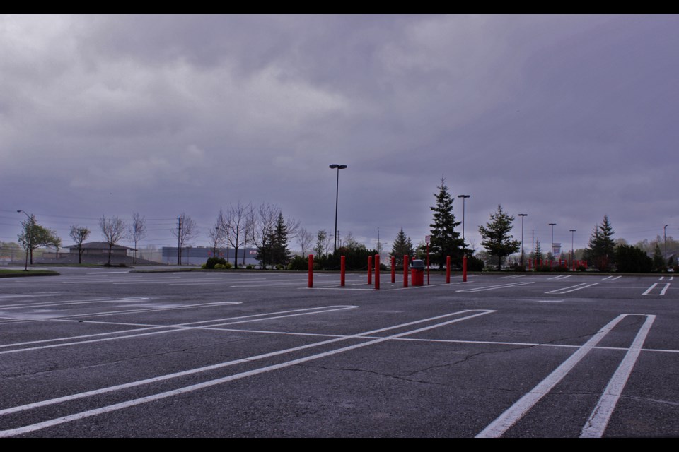 During normal business hours, most parking lots like this one are a crowd of cars, carts and shoppers. But not today — it being Victoria Day. (Callam Rodya/Sudbury.com)