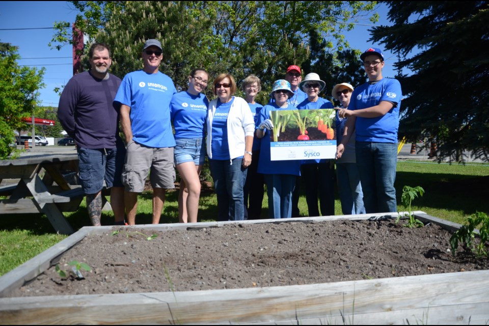 Union Gas retirees and other community members helped plant community gardens at Sudbury Food Bank on Saturday. (Arron Pickard