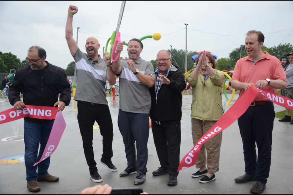 Brothers Kelly and Core Morel were joined by Sudbury MPP Glenn Thibeault, Sudbury Mayor Brian Bigger, Ward 11 Coun. Lynne Reynolds and Sudbury MP Paul Lefebvre in cutting the ribbon on the Morel Family Foundation Park on Second Avenue. (Arron Pickard/Sudbury.com)