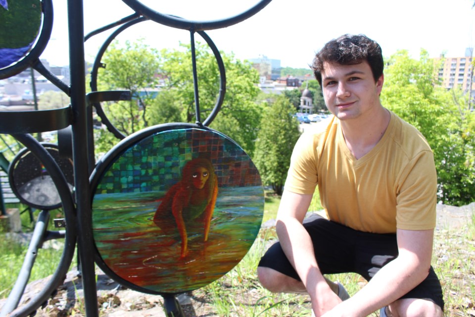 Sudbury Secondary School Grade 11 student Sean Clarke poses with art he created for the Green Stairs Art Walk 2017. Under the art direction of the artist Will Morin, more than 60 original pieces of art are framed and displayed creatively along the stairs. (Heather Green-Oliver/Sudbury.com)