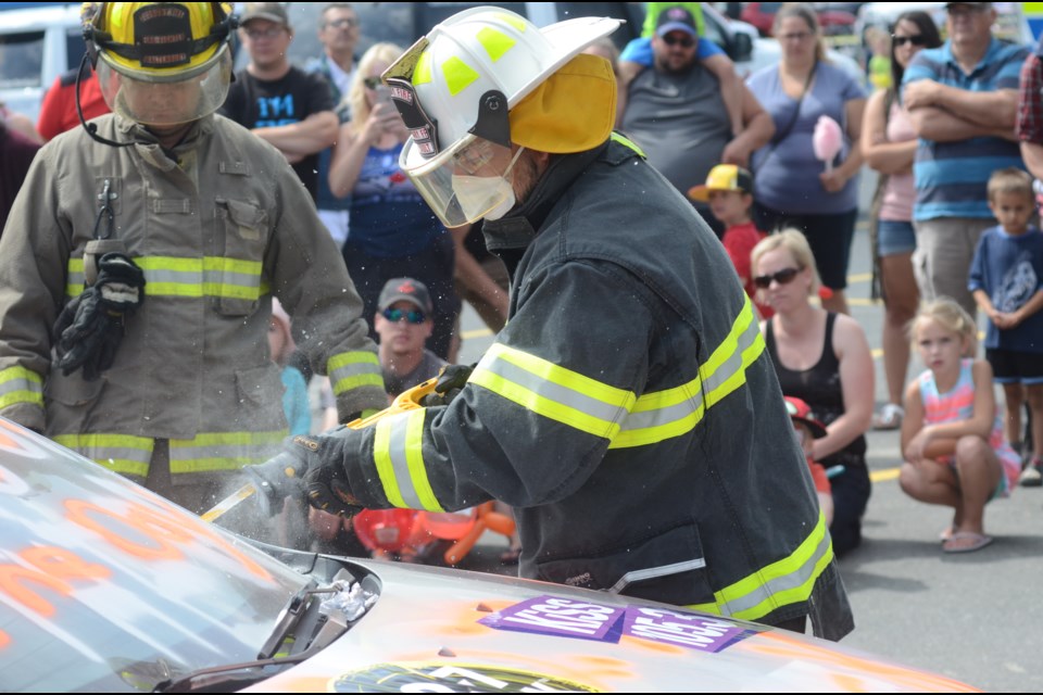 Sudbury MPP Glenn Thibeault cuts out the windshield of a car during an extraction demonstration at his annual salute to emergency services personnel barbecue. (Photo: Arron Pickard)
