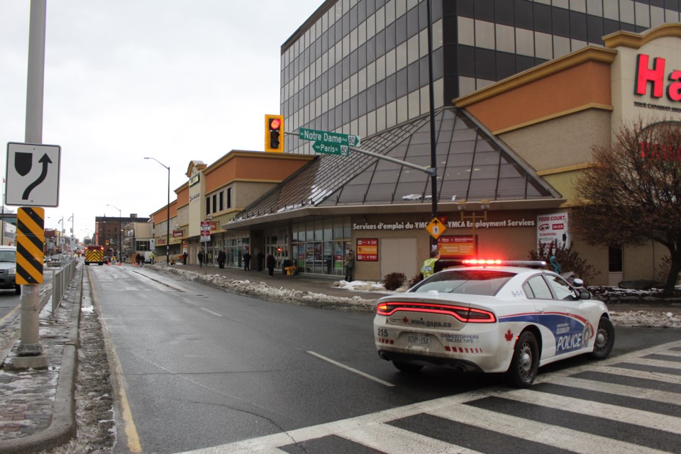 Greater Sudbury Police, along with Fire and Emergency Services have closed off the westbound lane on Elm Street from Paris Street to Durham Street. (Matt Durnan/Sudbury.com)