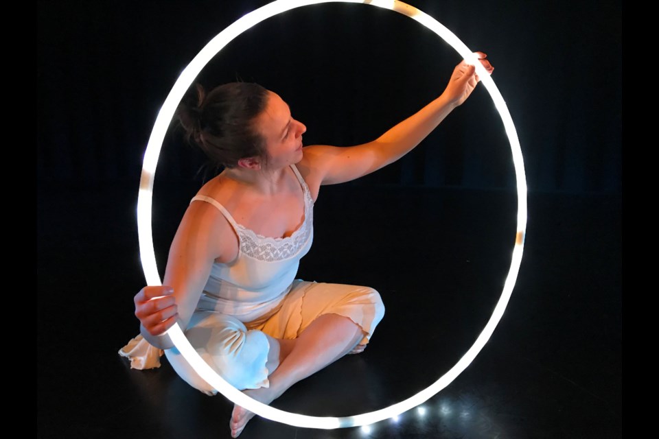 Melissa Roy of Tara Luz Danse is illuminated by a lighted hula hoop as part of Les Billes (Marbles), a dance performance that takes place at 2 p.m. on Saturday, Jan. 27. (Allana McDougall)