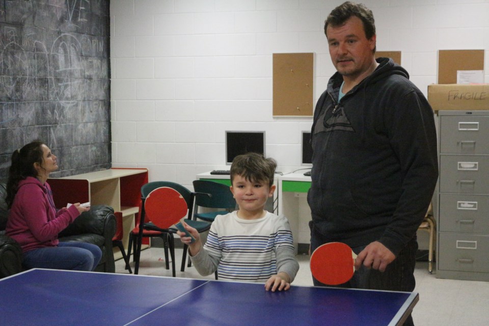 Amery Heckman and Justin Heckman get read for an intense game of ping pong at the YMCA. (Sudbury.com/Gia Patil)