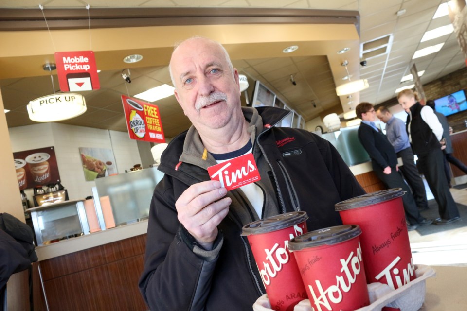 Pierre Laliberte thought he won a single free coffee when he rolled up the rim of his medium double-double that he purchased on the first day of the Tim Hortons Rrroll Up the Rim to Win Contest. It wasn't until four days later, when he went to redeem it at the Tim Hortons restaurant on Algonquin Road, that he learned he had actually won free coffee for a year. (Heather Green-Oliver/Sudbury.com)
