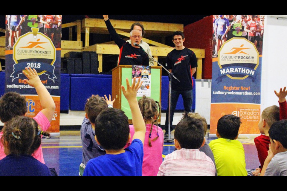 Sudbury Rocks committee member Vince Perdue rouses excitement amongst the students at Churchill Public School, who will be participating in the 1 k.m. run set to take place on May 13, 2018. (Allana McDougall/Sudbury.com)