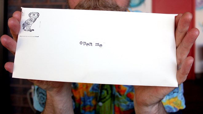 Scott Florence provides a closeup of one of the envelopes that is part of The Letter Project. (Ella Jane Myers photo)