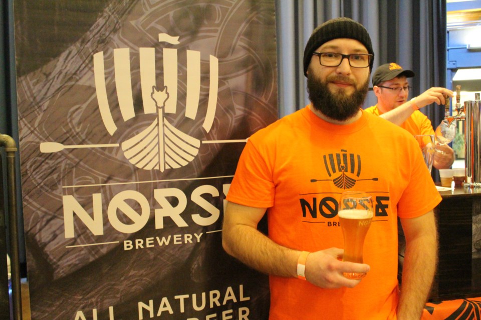 Dimitry Rogozhkin, manager at Parry Sound's Norse Brewery, holds his glass of ale. (Sudbury.com/Gia Patil)