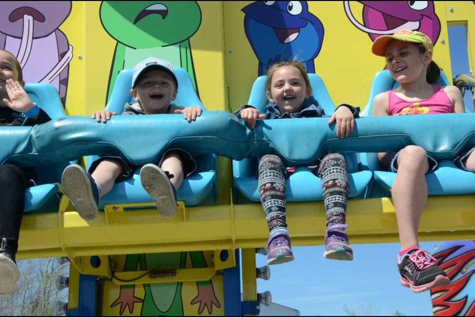 Ashton Piche, 3, and his sister, Anna-Lea Piche, 5, are all smiles on one of the Five Way Carnival rides. (Arron Pickard/Sudbury.com)
