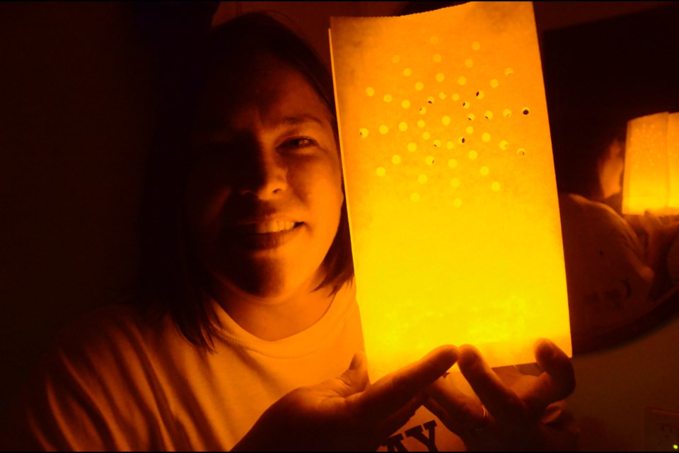 Cancer survivor Elizabeth Szilva shows off a luminary that can be purchased in support of the Canadian Cancer Society. The luminaries will be part of a special ceremony at the Relay for Life on June 15 at Laurentian University. (Arron Pickard/Sudbury.com)