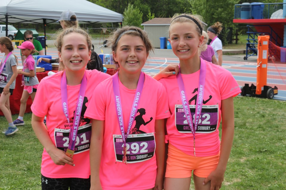 Brooke Williams, Raina McCan, and Abigail Coudmore Pose after finishing the race. (Sudbury.com/Gia Patil)