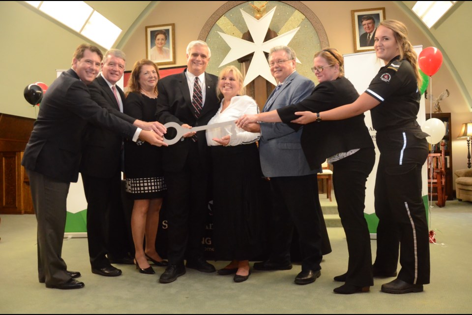 During the grand opening of St. John Ambulance's new home at 328 Albert St., a ceremony was held to symbolize handing over of  keys from the Lougheed family to the not-for-profit organization. From left to right are Sean Pretty, Gerry Lougheed Jr., Colette Lougheed, Geoffrey Lougheed, Heather Roy, Brian Cole, Beth Smith and volunteer Mandy Steele. (Arron Pickard)