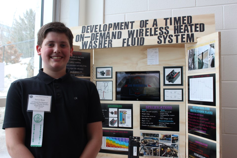 Trevor Meek from Carl A. Nesbitt Public School poses with his project, Development of a Timed On-Demand Wireless Heated Washer Fluid System, the first-place winner in the Engineering Junior Division of the 50th annual Sudbury Regional Science Fair. (Keira Ferguson/ Sudbury.com)
