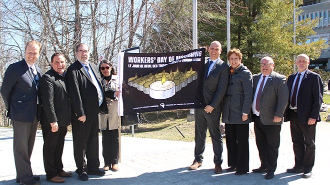 (From the left) MP Paul Lefebvre, MP Marc Serre, Leo W. Gerard, Debbie St. Germain, MPP Jamie West, MPP France Gelinas, Mayor Brian Bigger and Pierre Zundel, gathered in honour of the International Day of Mourning (Keira Ferguson/ Sudbury.com)