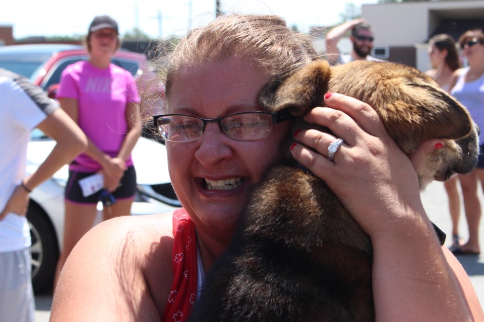 Amanda Gray holding Watson, at the Ontario SPCA adoption party hosted by First Round Sports Bar. (Keira Ferguson/ Sudbury.com)