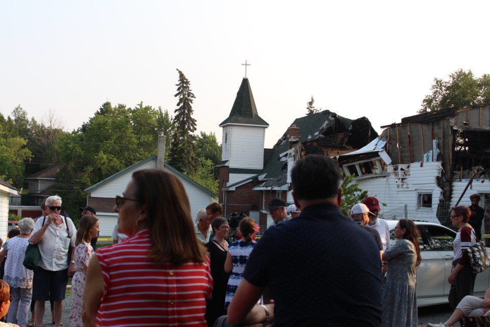 A group of more than 60 community members gathered in the parking lot of Grace United Church Thursday evening to say their final farewell to the building that was ravaged by a fire on July 24. (Matt Durnan/Sudbury.com)