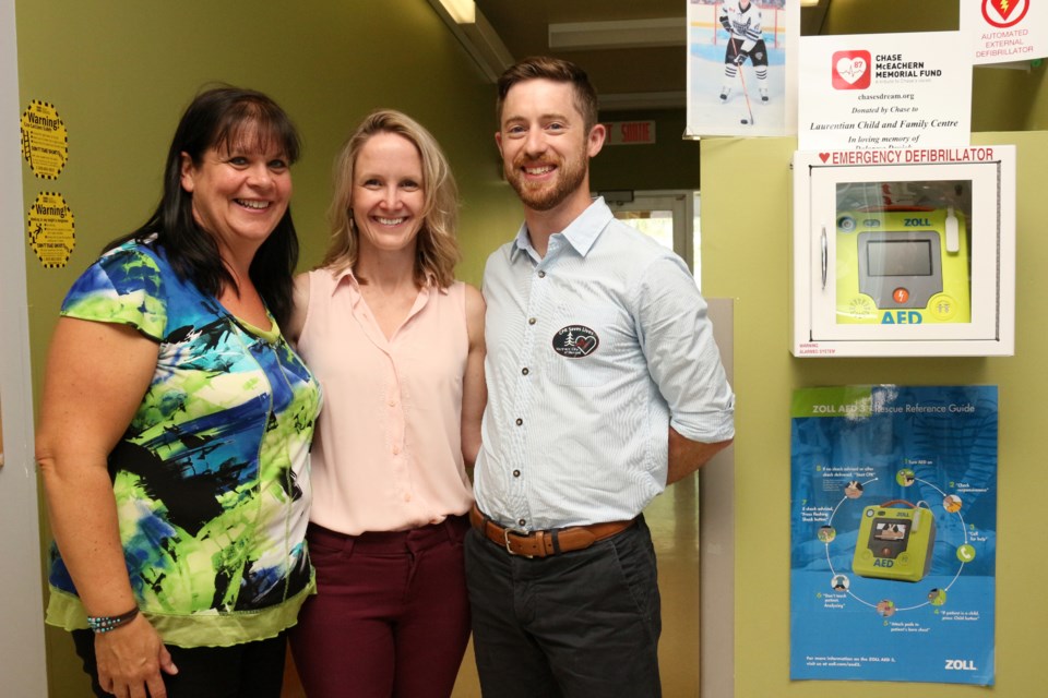 (From the left) Theresa Mills, executive director of the Laurentian Child and Family Centre with Dr. Sarah McIsaac and Dr. Robert Ohle, founders of the Northern City of Heroes initiative, at the presentation of the daycare's new Automated External Defibrillator. (Keira Ferguson/ Sudbury.com)