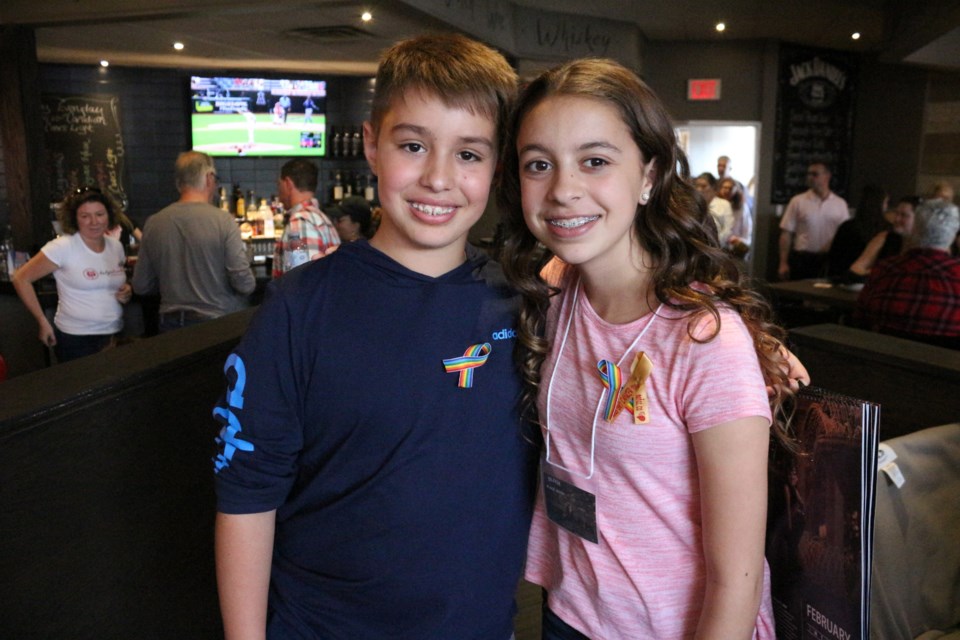Gabriel (left) with his sister Olivia Moreira (right) at the launch of the NOFCC 2020 Superhero Calendar at Social House Kitchen and Bar. (Keira Ferguson/ Sudbury.com)
