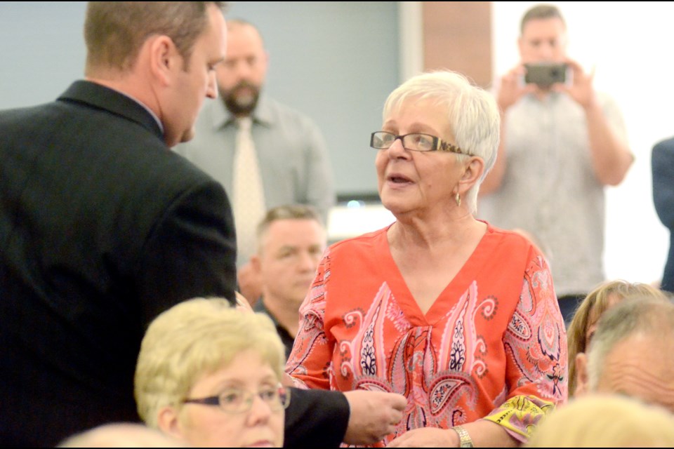 Estelle Lemieux receives a flower and pin in honour of her husband, Marcel Lemieux, who died in July from lung cancer. (Arron Pickard/Sudbury.com)