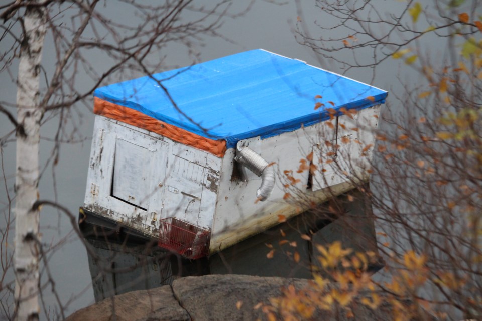 A lone ice hut is still marooned near the shore of Kelly Lake off Southview Drive, where it has been since the ice melted more than six months ago. (Matt Durnan/Sudbury.com)