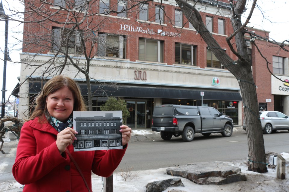 Brigitte Labby with a photo of the Durham Street building that used to house the city's Eaton's store, but is now home to the SRO bar and Peppi Panini restaurant. (Heidi Ulrichsen/Sudbury.com)